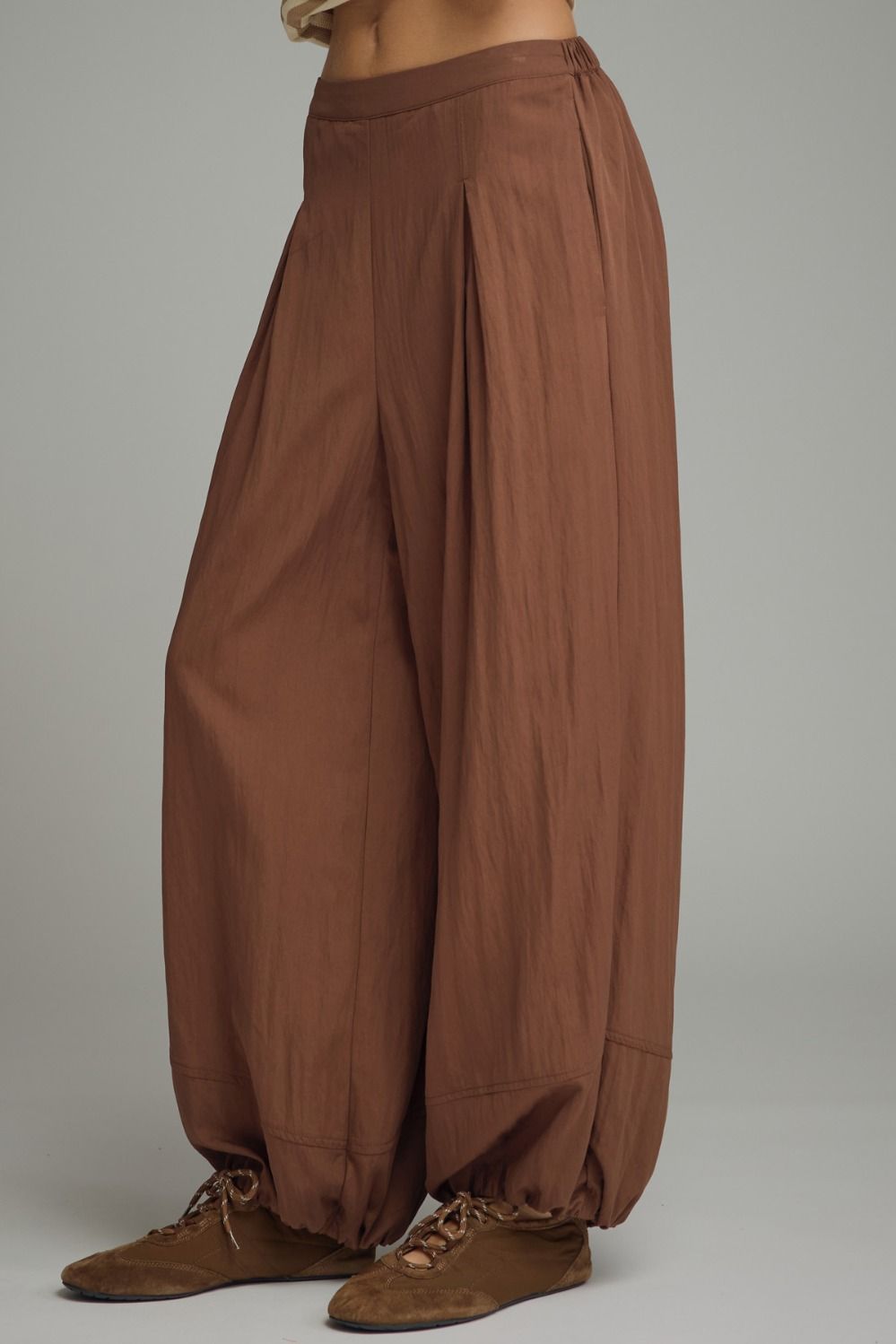 Solid pants featuring pleated front detail