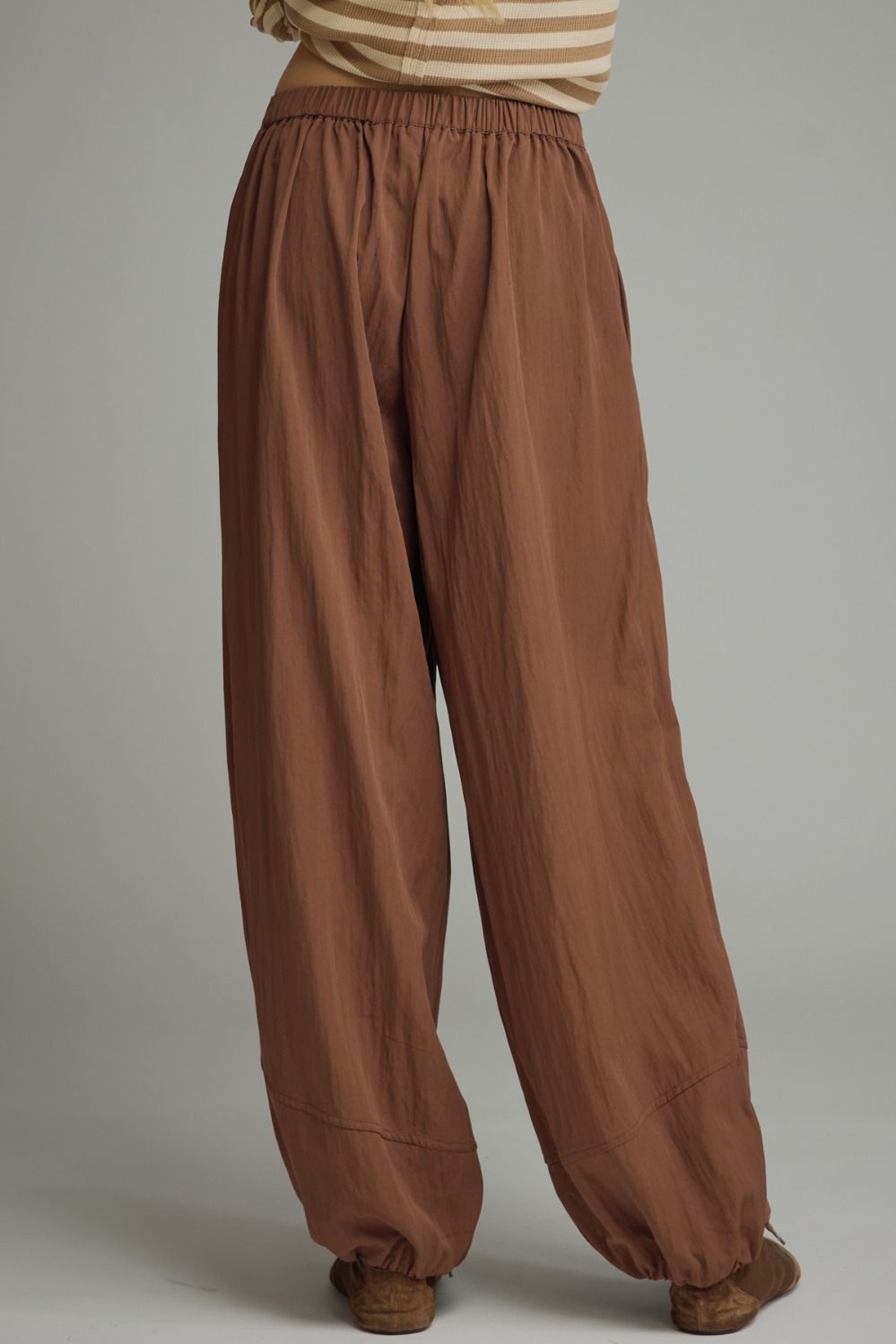 Solid pants featuring pleated front detail