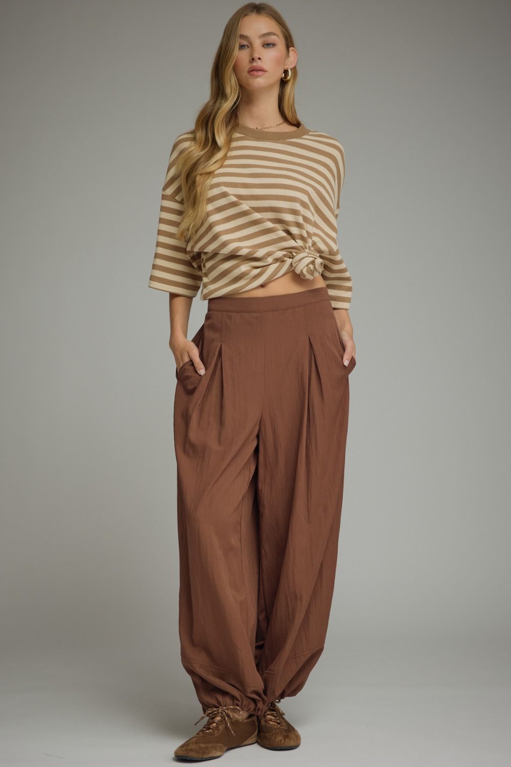 Solid pants featuring pleated front detail