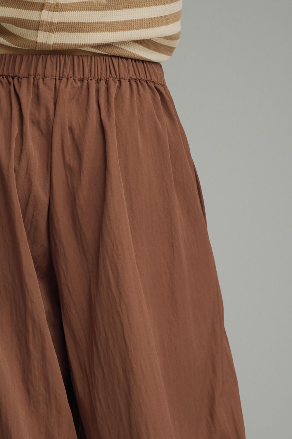 Solid pants featuring pleated front detail