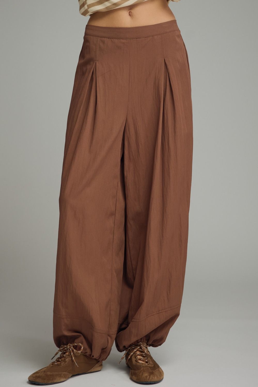 Solid pants featuring pleated front detail
