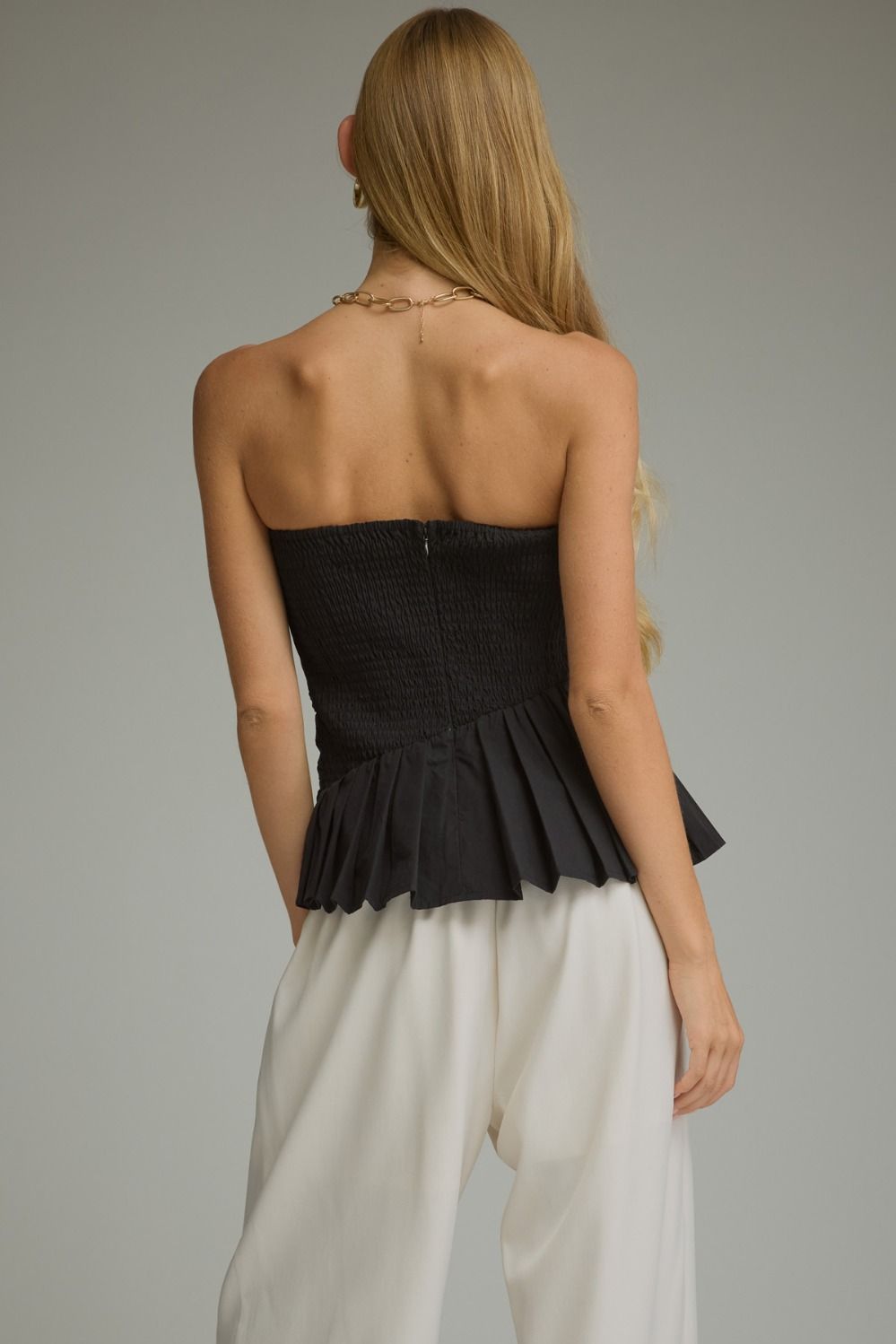 Solid strapless top with pleated detail