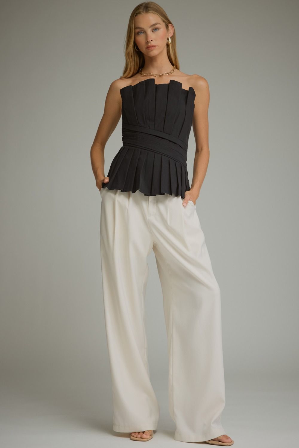 Solid strapless top with pleated detail