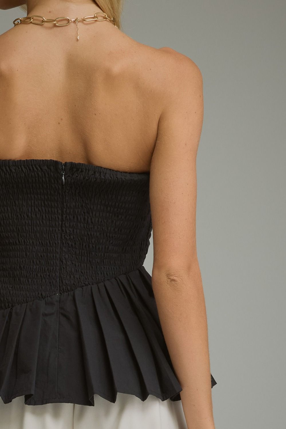 Solid strapless top with pleated detail